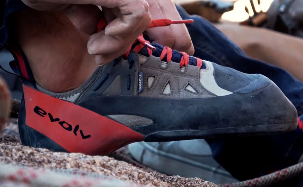 climber putting on Evolv Oracle shoes