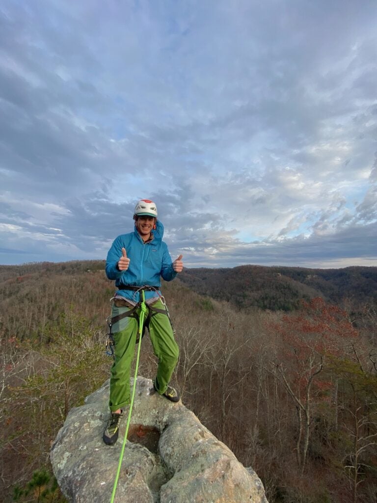 AMGA guide teddy at the top of a sport route in red river gorge